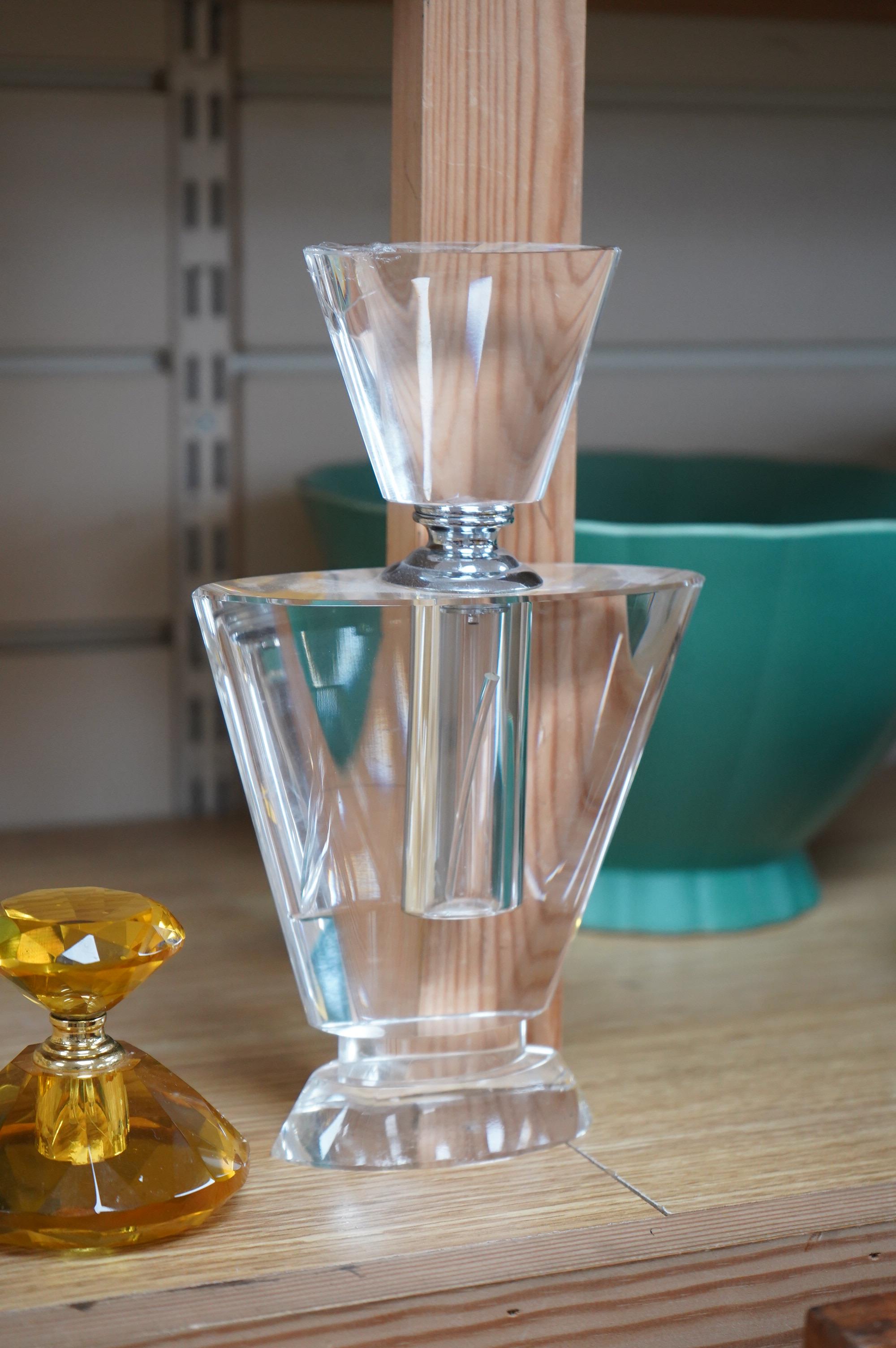 An amber glass perfume bottle and an oversized Art Deco style glass perfume bottle